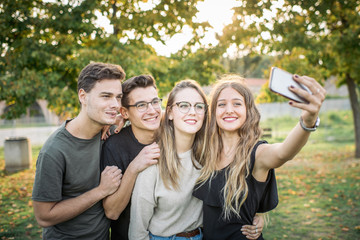 Cityscapes and Skylines - Group of friends taking a self portrait in the park.