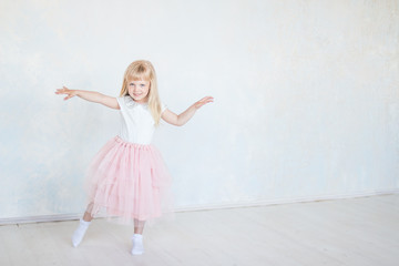 happy beautiful baby girl dancer dancing modern dance. Little cute child jumping, running, dancing, having fun. party dancing concept.Baby girl is studying ballet, modern dance.copy space