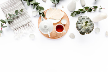 Breakfast with cheese, leaves eucalyptus, cutting board and black tea composition with on white...
