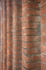 The pillars of the fence made of red brick shaped