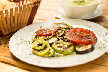 Grilled vegetables and cabbage salad, bread on a wooden table. The concept of healthy eating.
