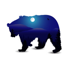 Silhouette of bear with panorama of mountains. Moonlight. Winter.