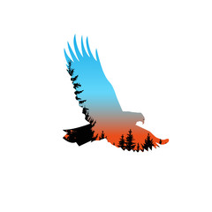 Silhouette of eagle with coniferous trees on the background of colorful  sky. Blue and orange tones.