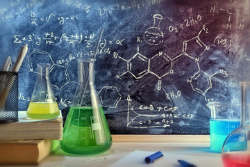 Classroom desk and drawn blackboard of chemistry teaching general view - obrazy, fototapety, plakaty