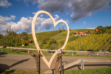 Herz aus Holz vor idyllischem Weinberg