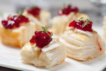 Holiday appetizers with cranberry, brie and thyme