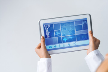 Close of female doctor hands working with tablet pc computer