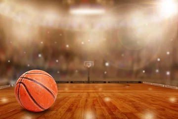  Fictitious basketball arena with ball on court and copy space. Camera flashes and lens flare special lighting effect on defocused background. © ronniechua