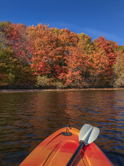 Autumn foliage with kayak in the foreground. Colorful Fall leaves in New Brunswick, Canada