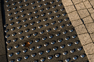 Sidewalk guides for blind. Concrete cobblestones on walkway for blindness people