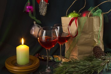 conflagrant candle and two glasses with red wine. Christmas together .