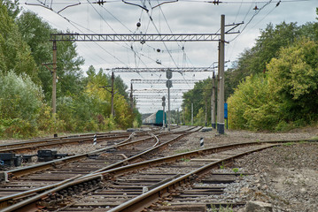 Railway station and train in the background of a forest and a beautiful sky. Landscape with the railway and train, Travel.