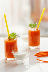 Two glasses of carrot juice and cream