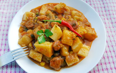 Stewed potatoes on white plate
