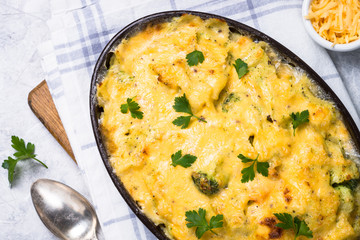 Gratin or Casserole in baking dish. Pasta fish cheese and vegetables. Top view.