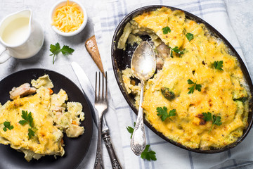 Gratin or Casserole in baking dish. Pasta fish cheese and vegetables. Top view.