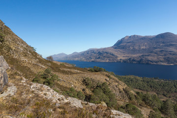 Fototapeta na wymiar View of Loch Maree and mountain Slioch from the mountain trails in Beinn Eighe Nature Reserve.
