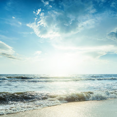 Fototapeta na wymiar sea with waves and blue sky in sunset