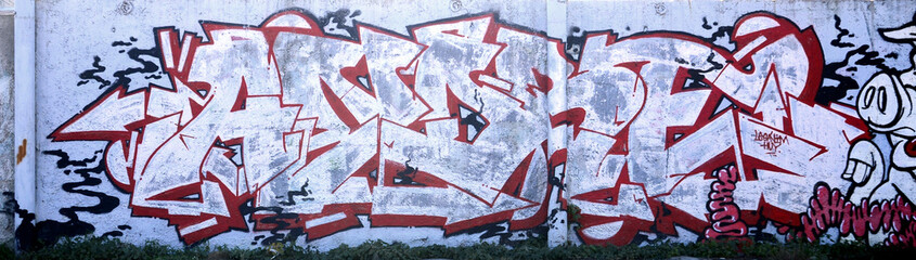 The texture of the wall with graffiti, which is depicted on it. The image of the whole and complete graffiti of the drawing as a resource for the design of 3D projects