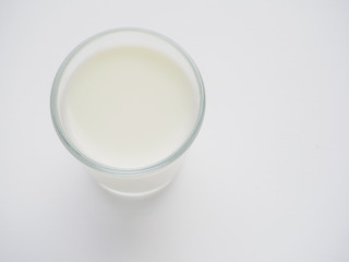 A glass of milk on light background. The view from the top.