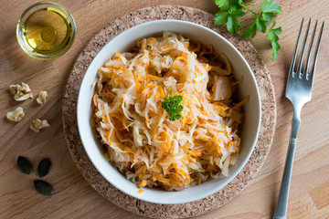 Fermented cabbage and carrots in a bowl, top view