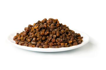 Propolis granules inside plate, bee product