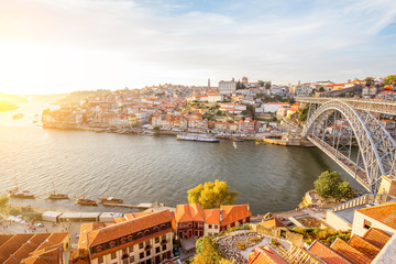 Panoramic landscape view on the old town with Douro river and famous iron bridge in Porto city during the sunset in Portugal © rh2010
