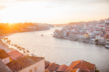 Aerial landscape view on the Douro river and old town of Porto during the sunset in Portugal