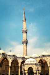 Fototapeta na wymiar Beautiful minaret against the background of a bright cloudy sky