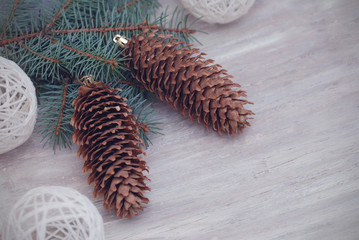 Pine Cone and Christmas tree Fir Branches and Decorations with Copy Space on old Rustic Backgorund