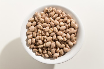 Pinto Bean legume. Top view of grains in a bowl. White background