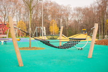Modern equipped kids playground in sunny day. Set of hammocks