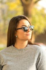 Beautiful young smiling girl headshot portrait with blurred background