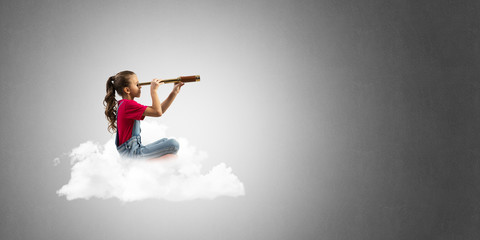 Concept of careless happy childhood with girl dreaming about future