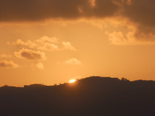 Sunset behind mountain And the evening sky