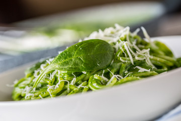 Spaghetti. Green spaghetti with spinach and parmesan. Italian and mediterranean cuisine