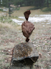 rock stacking in forest in winter, rocks in balance  