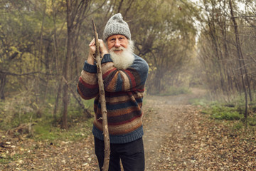 old man with beard in forest