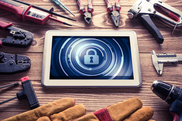 Web security and technology concept with tablet pc on wooden tab © adam121
