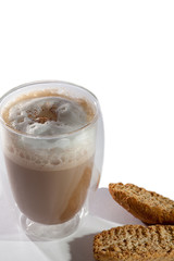 Frothy cappuccino coffee with almond biscotti biscuits on white background