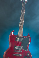 Fototapeta na wymiar electric guitar in smoke, blue background