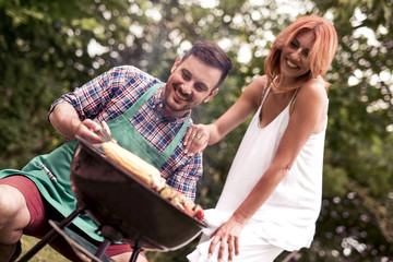 Young people having a barbecue party in the backyard