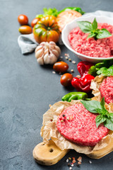 Homemade raw organic minced beef meat burger cutlet and vegetables