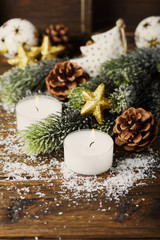 Obraz na płótnie Canvas Christmas ornament with cone, candles and snow, selective focus