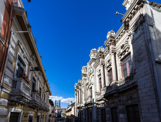 Fototapeta na wymiar Quito, Ecuador: Buildings of neoclassical style in the historical center of the city with the typical blue sky of summer.