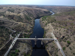 Obraz premium Puente romano de Alcántara, pueblo de Cáceres en Extremadura (España) situado en la orilla del río Tajo, confluencia con el río Alagón, cerca de Portugal. Fotografia aerea con Drone