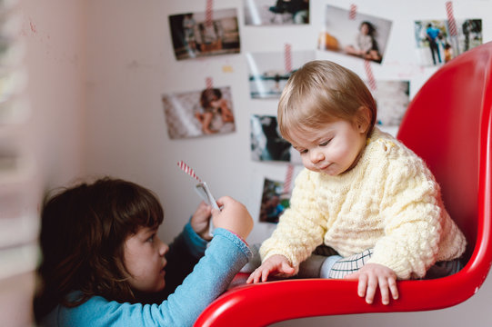 siblings observing photos together