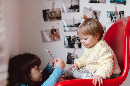 siblings observing photos together