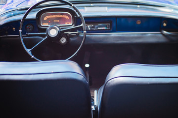 Black leather interior of a vintage car