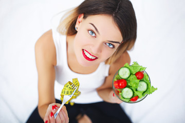 Nutrition. Beautiful Woman On Healthy Diet With Organic Green Vegetable Salad In Kitchen. Smiling Girl Sitting At bed With Different Food Ingredients, Variety Of Foods And Products. High Resolution